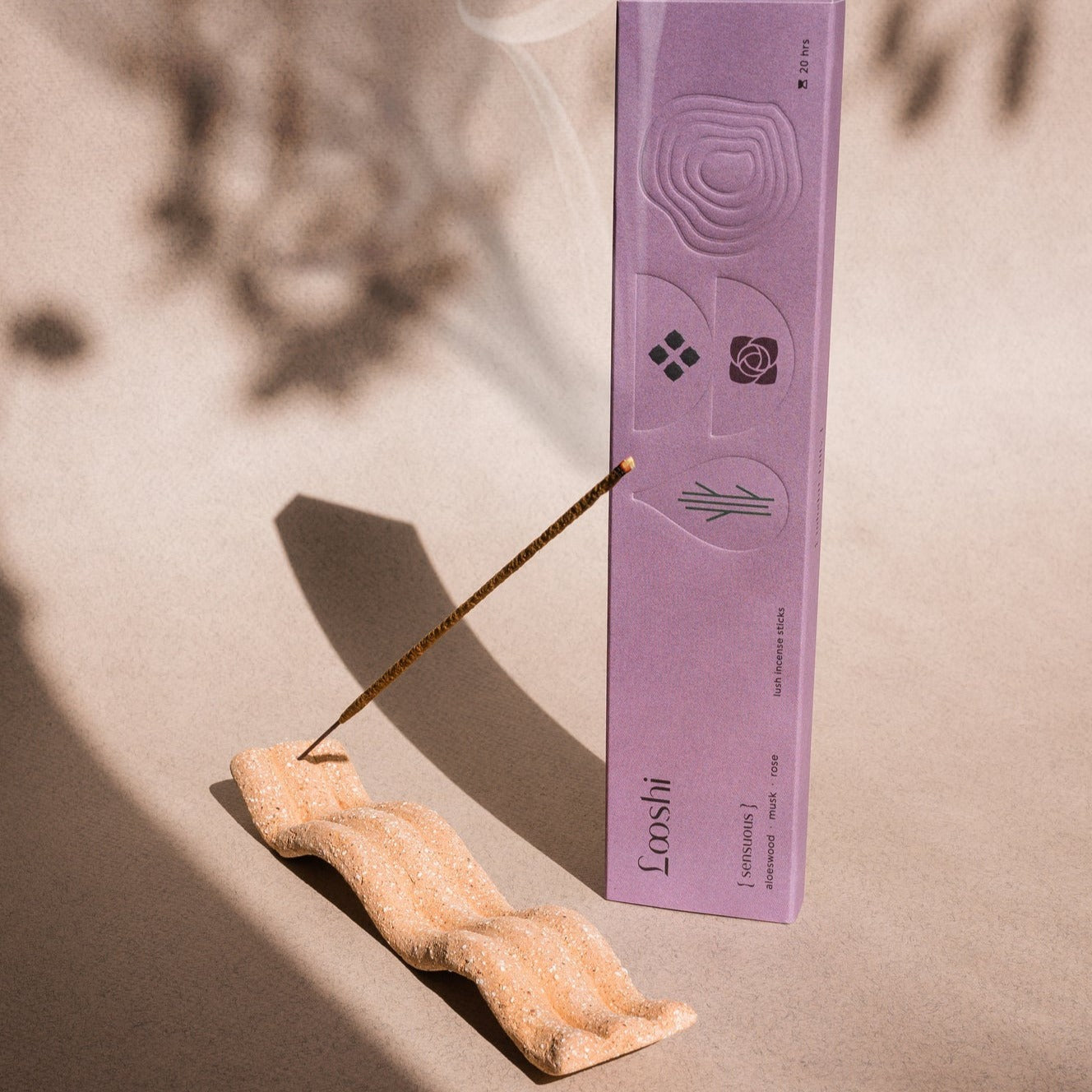 Elongated tray incense holder with imprinted wave pattern. The Wave of Senses symbolizes the undulating motion made by incense fragrance as it disperses throughout the room. The Wave holds the incense stick and catches ash as it falls.