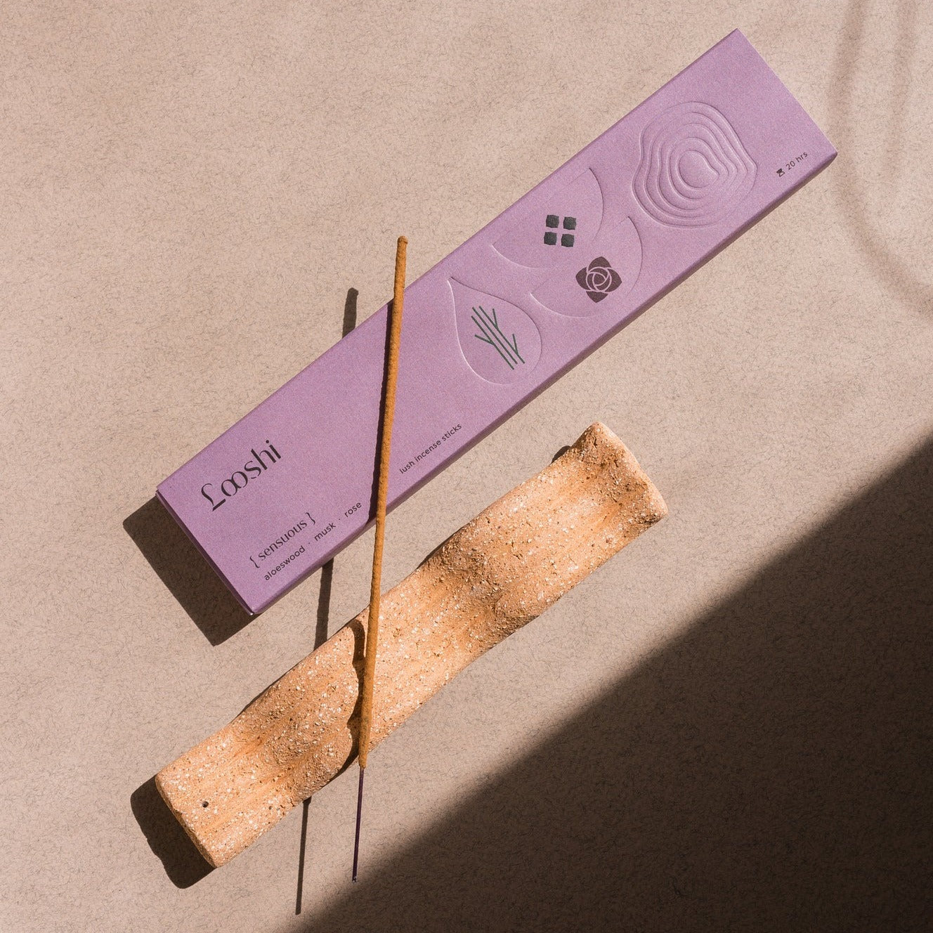 Elongated tray incense holder with imprinted wave pattern. The Wave of Senses symbolizes the undulating motion made by incense fragrance as it disperses throughout the room. The Wave holds the incense stick and catches ash as it falls.